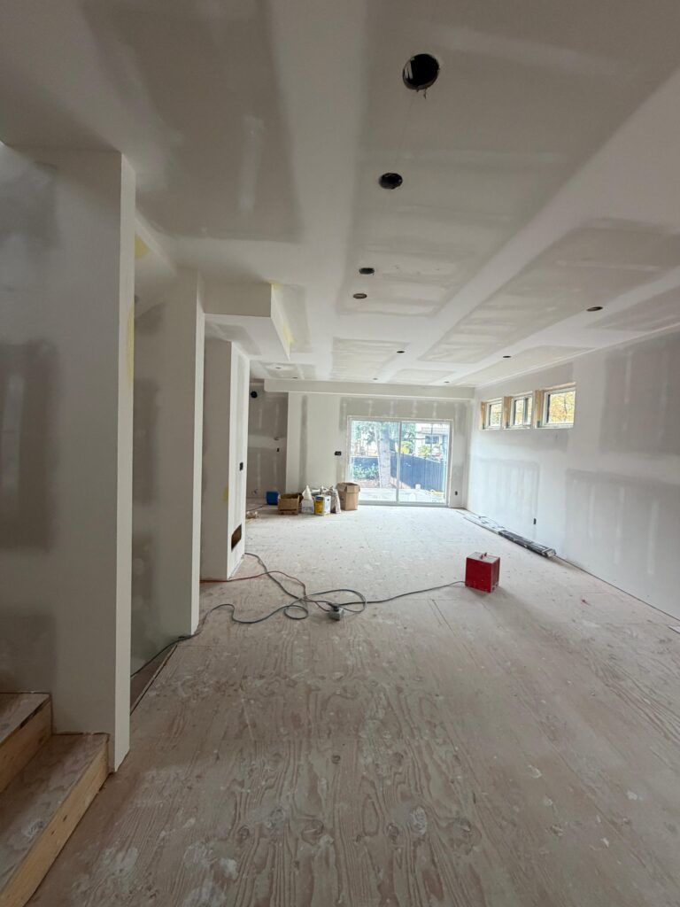 Finished drywall walls and ceiling in an open-plan room